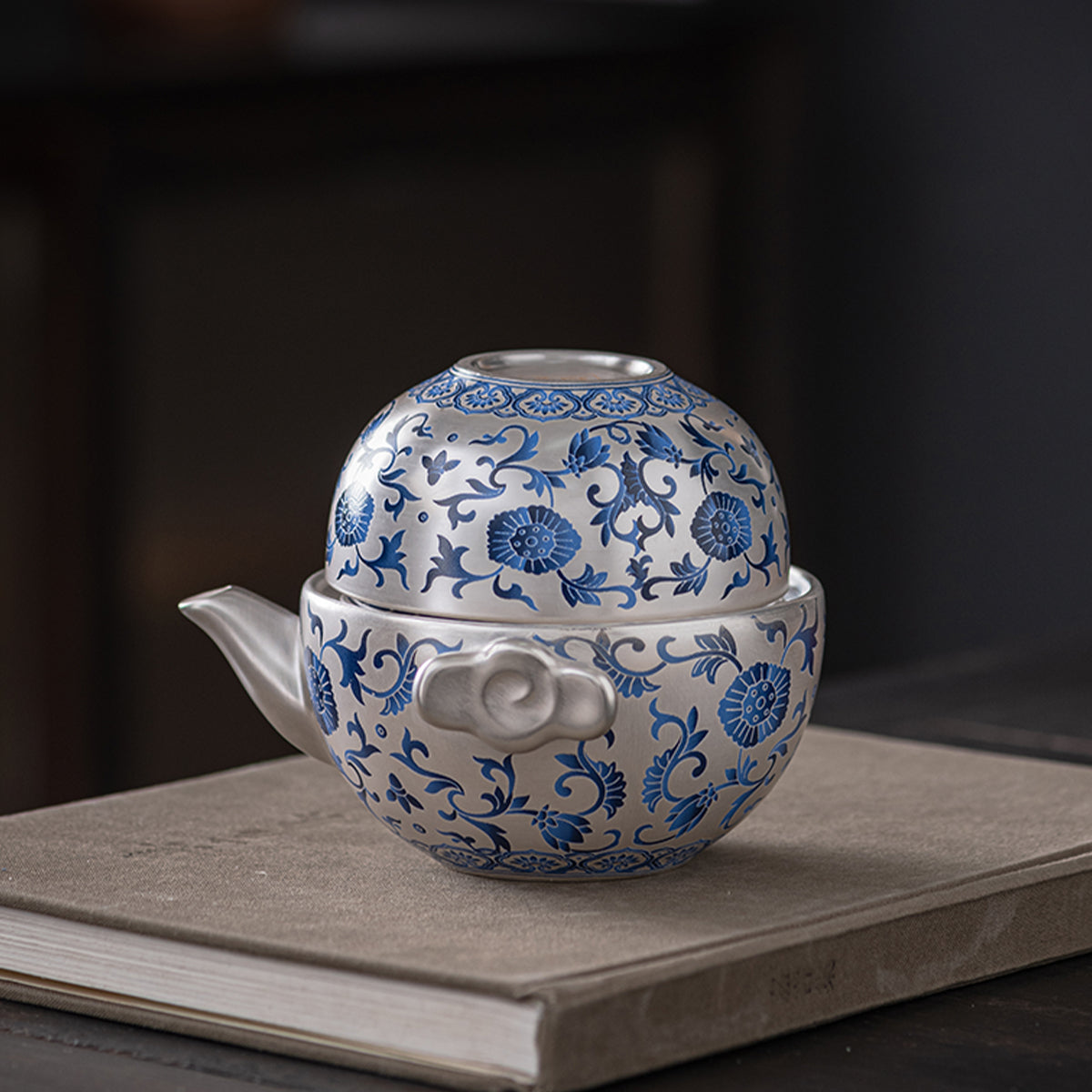 A silver-inlaid lotus-branch patterned teapot with two cups. Chaliland