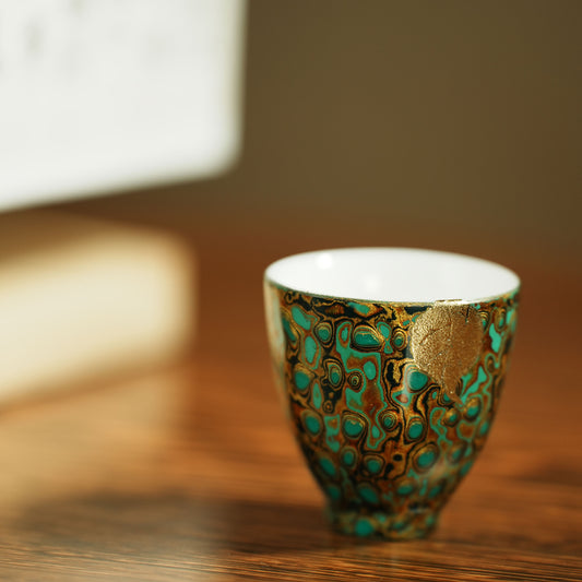 Host cup with a green peacock feather pattern as the background color and gold texture.