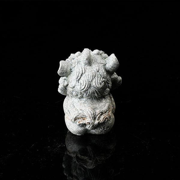 This is a lion dance tea pet holding a gold ingot.
