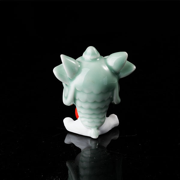 This is a lucky cat tea pet wearing a lion dance hat.