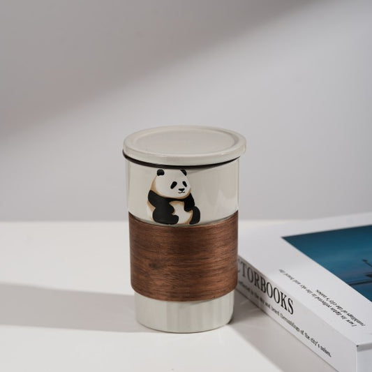 This is a branded teacup with accessories including a teacup with a lid and a filter pot in the teacup. The brand is Jade Peak Reserve. There is a wooden anti-scalding plate on one side of the cup and a cute panda on the other side.