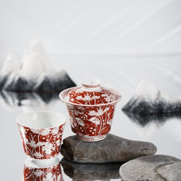 This is a red-bottomed Gaiwan with white patterns, depicting a egret playing among lotus leaves. The theme is "One egret wins the first prize", which means the blessing for students who win the college entrance examination in ancient China.