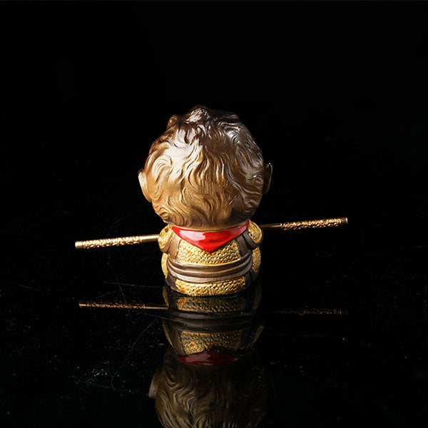 This is the Son Wukong tea pet sitting cross-legged on the ground, holding the golden hoop stick.