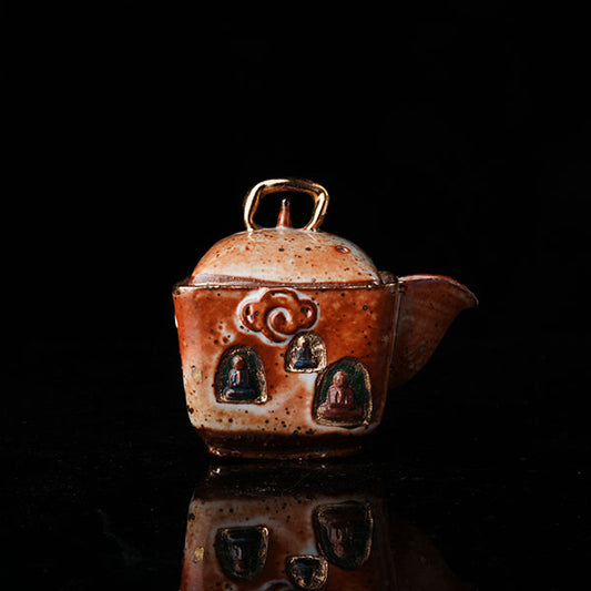 The Buddha without Form Square Teapot - Traditional ceramic teapot with square form, speckled brown glaze, gold handle, and relief figures (possibly Buddhist motifs). Handcrafted, rustic design, ideal for tea rituals. Features intricate detailing, cultural artistry, and functional elegance. Perfect for collectors of unique teaware, highlighting craftsmanship and traditional aesthetics.