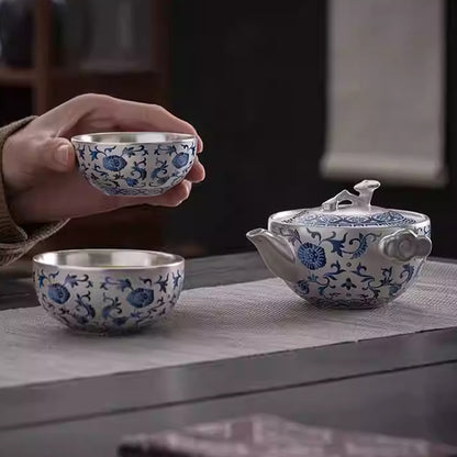 A silver-inlaid lotus-branch patterned teapot with two cups. Chaliland