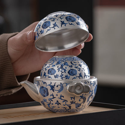 A silver-inlaid lotus-branch patterned teapot with two cups. Chaliland