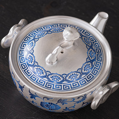 A silver-inlaid lotus-branch patterned teapot with two cups. Chaliland