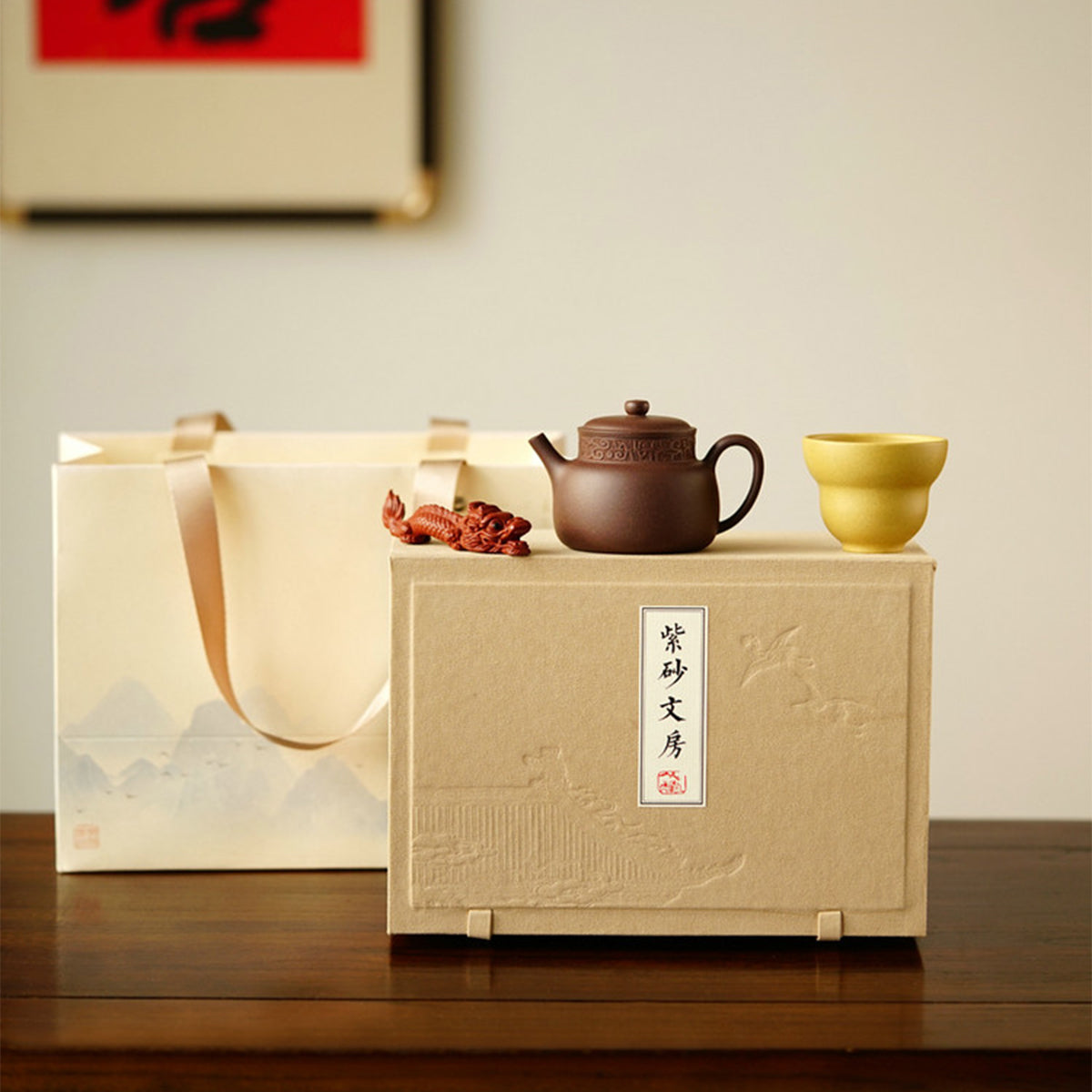 A teapot, a cup, and a tea pet gift box from Jiquan. Chaliland
