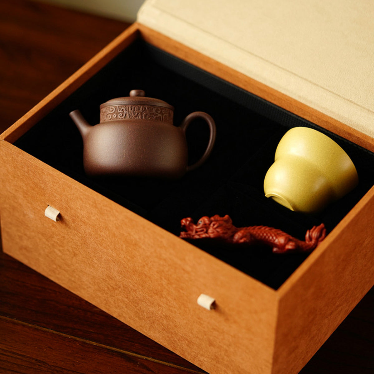 A teapot, a cup, and a tea pet gift box from Jiquan. Chaliland