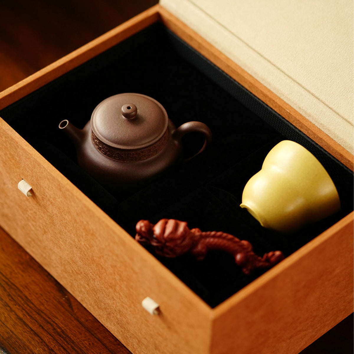A teapot, a cup, and a tea pet gift box from Jiquan. Chaliland