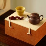 A teapot, a cup, and a tea pet gift box from Jiquan. Chaliland