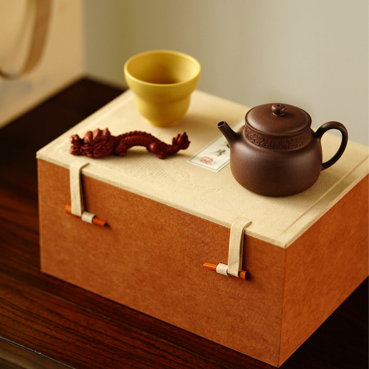 A teapot, a cup, and a tea pet gift box from Jiquan. Chaliland