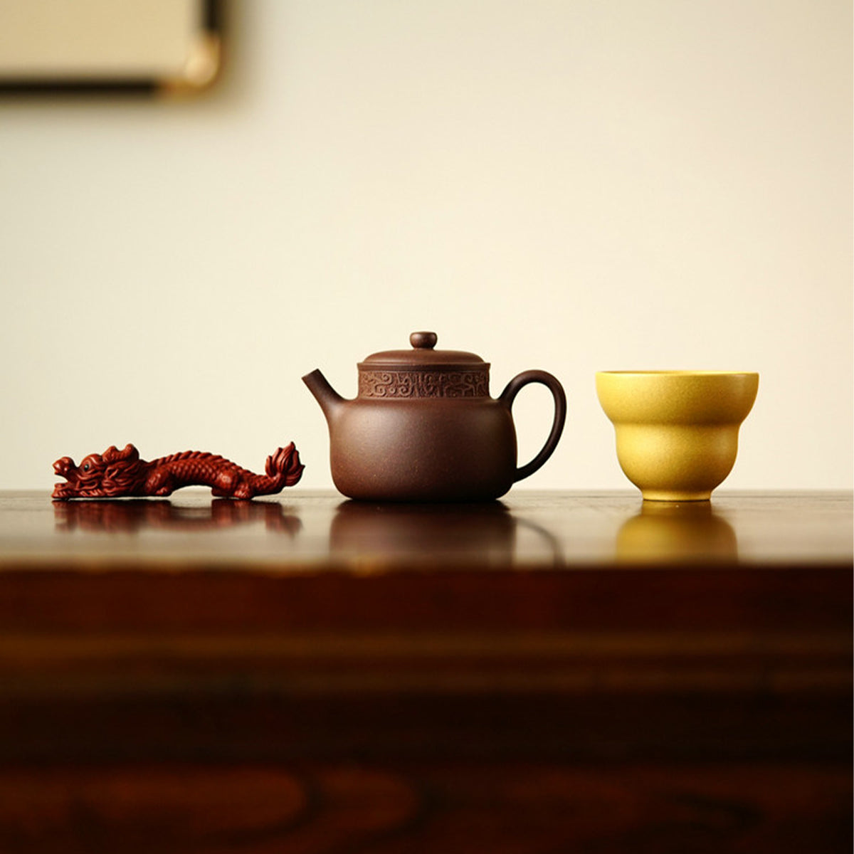 A teapot, a cup, and a tea pet gift box from Jiquan. Chaliland