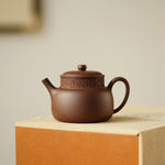 A teapot, a cup, and a tea pet gift box from Jiquan. Chaliland