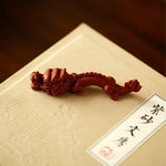 A teapot, a cup, and a tea pet gift box from Jiquan. Chaliland