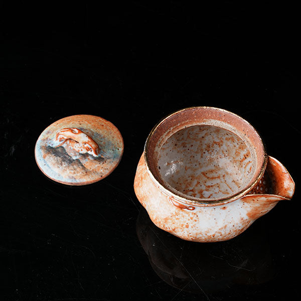Classic of Mountains and Seas Teapot - Traditional ceramic teapot with rustic glaze, featuring mythical creature motifs inspired by Shan Hai Jing. Handcrafted, earthy tones, lid with handle, ideal for tea rituals. Showcases cultural artistry, intricate detailing, and functional elegance. Perfect for collectors of unique teaware, blending mythology with craftsmanship. 