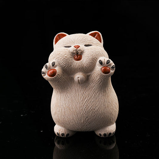 This is a hamster tea pet with its paws raised high, wanting to be hugged by its owner.