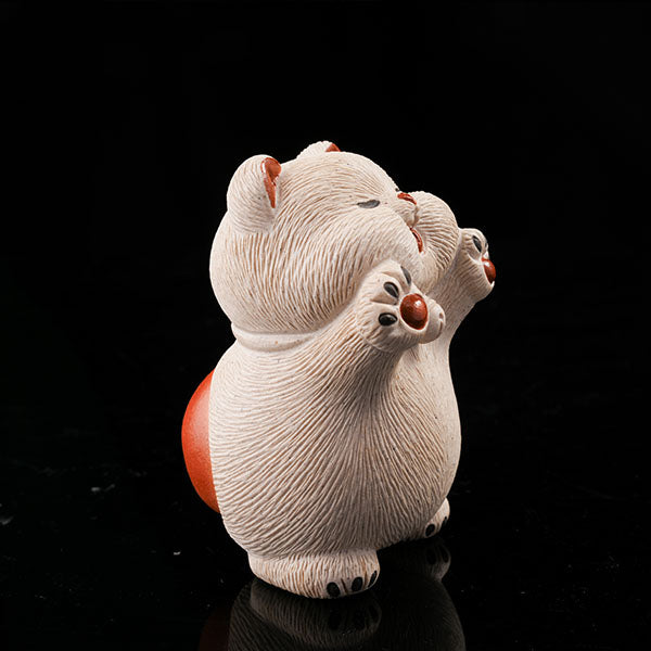 This is a hamster tea pet with its paws raised high, wanting to be hugged by its owner.