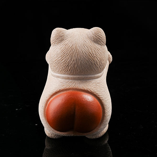 This is a hamster tea pet with its paws raised high, wanting to be hugged by its owner.