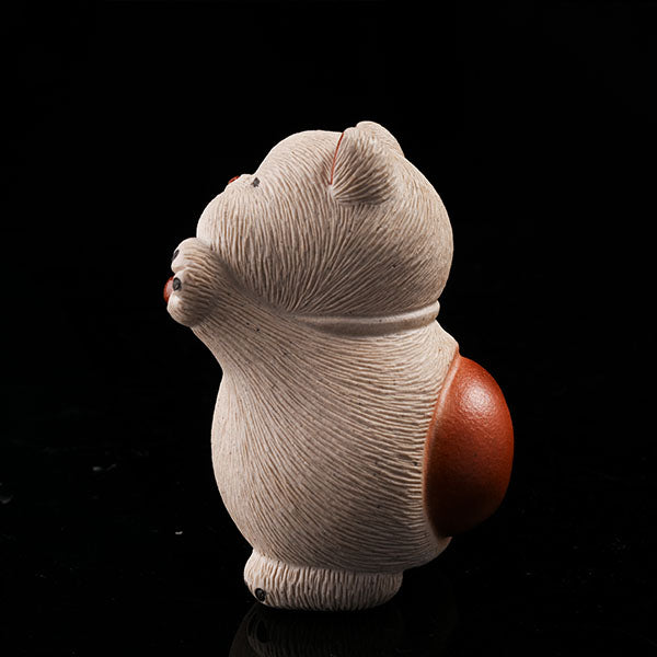 This is a hamster tea pet with its paws raised high, wanting to be hugged by its owner.