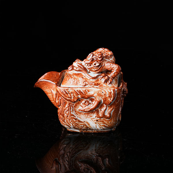 Loong Pattern Teapot - Traditional Chinese ceramic teapot featuring intricate dragon (loong) relief, rustic brown glaze, square shape, and dragon-adorned lid. Handcrafted, embodying cultural heritage, ideal for tea ceremonies. Showcases detailed artistry, perfect for collectors of Asian teaware, blending craftsmanship with functional elegance. 