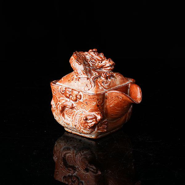 Loong Pattern Teapot - Traditional Chinese ceramic teapot featuring intricate dragon (loong) relief, rustic brown glaze, square shape, and dragon-adorned lid. Handcrafted, embodying cultural heritage, ideal for tea ceremonies. Showcases detailed artistry, perfect for collectors of Asian teaware, blending craftsmanship with functional elegance. 