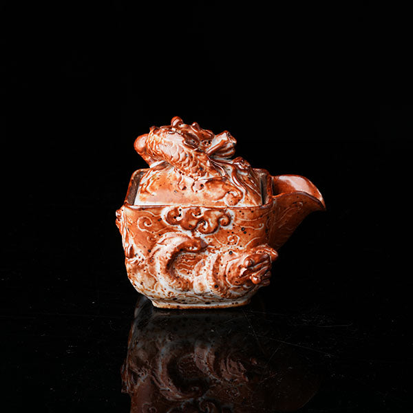 Loong Pattern Teapot - Traditional Chinese ceramic teapot featuring intricate dragon (loong) relief, rustic brown glaze, square shape, and dragon-adorned lid. Handcrafted, embodying cultural heritage, ideal for tea ceremonies. Showcases detailed artistry, perfect for collectors of Asian teaware, blending craftsmanship with functional elegance. 