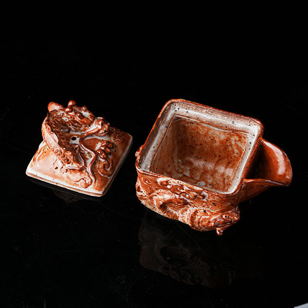 Loong Pattern Teapot - Traditional Chinese ceramic teapot featuring intricate dragon (loong) relief, rustic brown glaze, square shape, and dragon-adorned lid. Handcrafted, embodying cultural heritage, ideal for tea ceremonies. Showcases detailed artistry, perfect for collectors of Asian teaware, blending craftsmanship with functional elegance. 