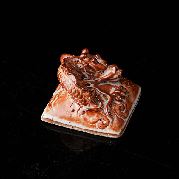 Loong Pattern Teapot - Traditional Chinese ceramic teapot featuring intricate dragon (loong) relief, rustic brown glaze, square shape, and dragon-adorned lid. Handcrafted, embodying cultural heritage, ideal for tea ceremonies. Showcases detailed artistry, perfect for collectors of Asian teaware, blending craftsmanship with functional elegance. 