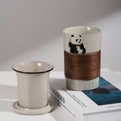 This is a branded teacup with accessories including a teacup with a lid and a filter pot in the teacup. The brand is Jade Peak Reserve. There is a wooden anti-scalding plate on one side of the cup and a cute panda on the other side.