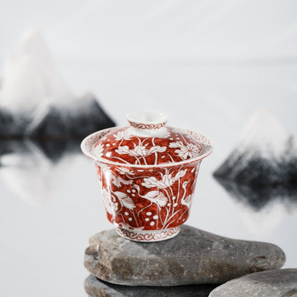 This is a red-bottomed Gaiwan with white patterns, depicting a egret playing among lotus leaves. The theme is "One egret wins the first prize", which means the blessing for students who win the college entrance examination in ancient China.