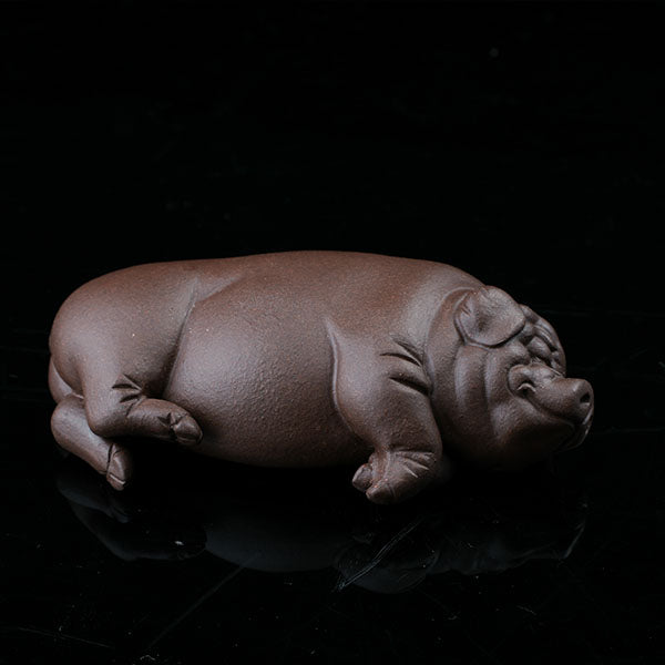 This is a pig tea pet that has fallen into a deep sleep.