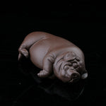 This is a pig tea pet that has fallen into a deep sleep.