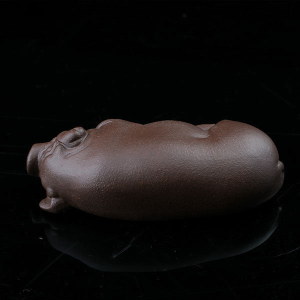 This is a pig tea pet that has fallen into a deep sleep.
