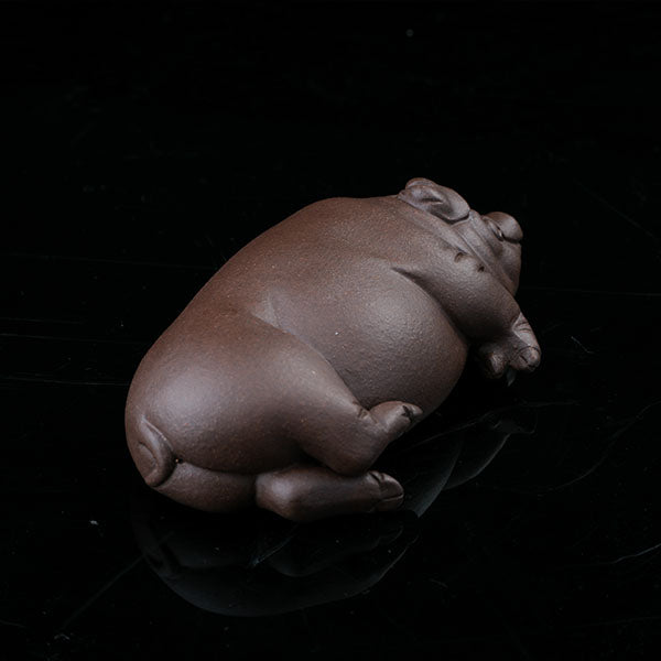 This is a pig tea pet that has fallen into a deep sleep.