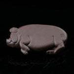 This is a pig tea pet that has fallen into a deep sleep.