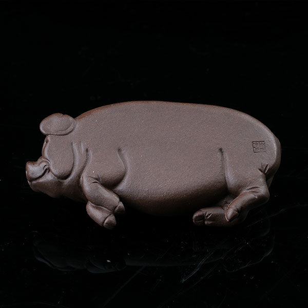 This is a pig tea pet that has fallen into a deep sleep.