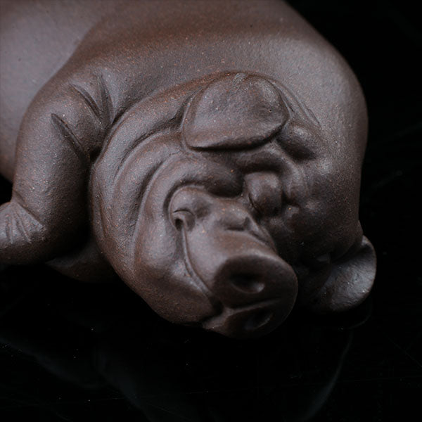 This is a pig tea pet that has fallen into a deep sleep.