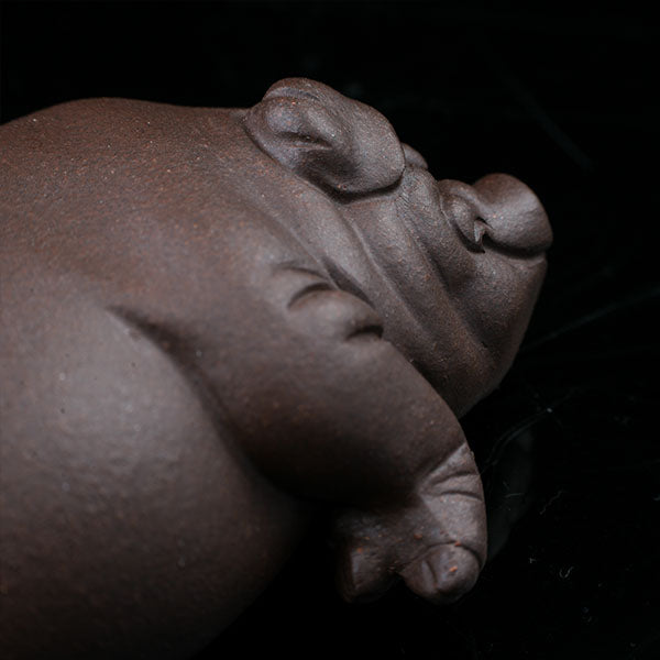 This is a pig tea pet that has fallen into a deep sleep.