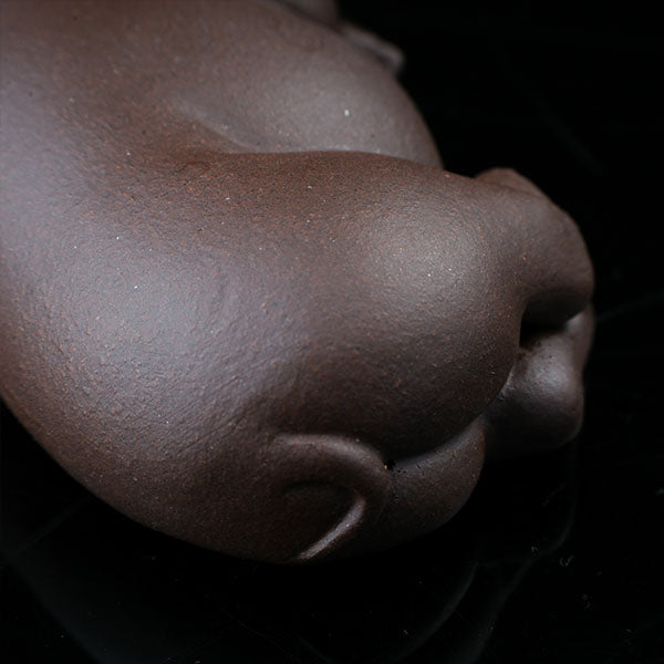 This is a pig tea pet that has fallen into a deep sleep.