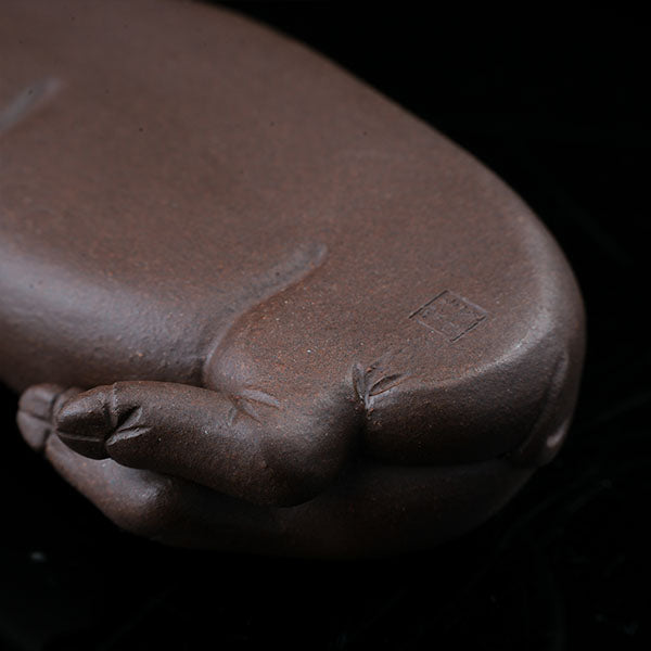 This is a pig tea pet that has fallen into a deep sleep.