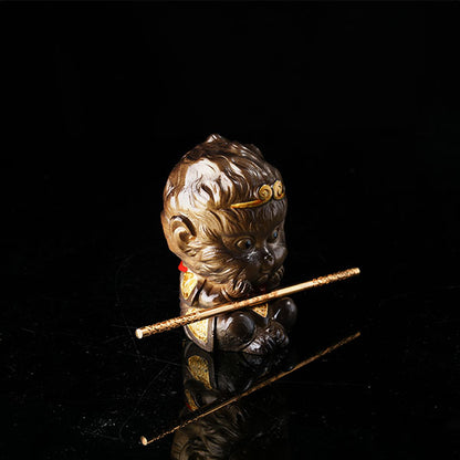 This is the Son Wukong tea pet sitting cross-legged on the ground, holding the golden hoop stick.