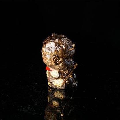 This is the Son Wukong tea pet sitting cross-legged on the ground, holding the golden hoop stick.