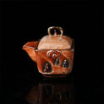 The Buddha without Form Square Teapot - Traditional ceramic teapot with square form, speckled brown glaze, gold handle, and relief figures (possibly Buddhist motifs). Handcrafted, rustic design, ideal for tea rituals. Features intricate detailing, cultural artistry, and functional elegance. Perfect for collectors of unique teaware, highlighting craftsmanship and traditional aesthetics.