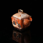 The Buddha without Form Square Teapot - Traditional ceramic teapot with square form, speckled brown glaze, gold handle, and relief figures (possibly Buddhist motifs). Handcrafted, rustic design, ideal for tea rituals. Features intricate detailing, cultural artistry, and functional elegance. Perfect for collectors of unique teaware, highlighting craftsmanship and traditional aesthetics.