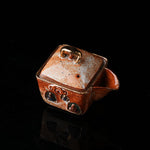 The Buddha without Form Square Teapot - Traditional ceramic teapot with square form, speckled brown glaze, gold handle, and relief figures (possibly Buddhist motifs). Handcrafted, rustic design, ideal for tea rituals. Features intricate detailing, cultural artistry, and functional elegance. Perfect for collectors of unique teaware, highlighting craftsmanship and traditional aesthetics.