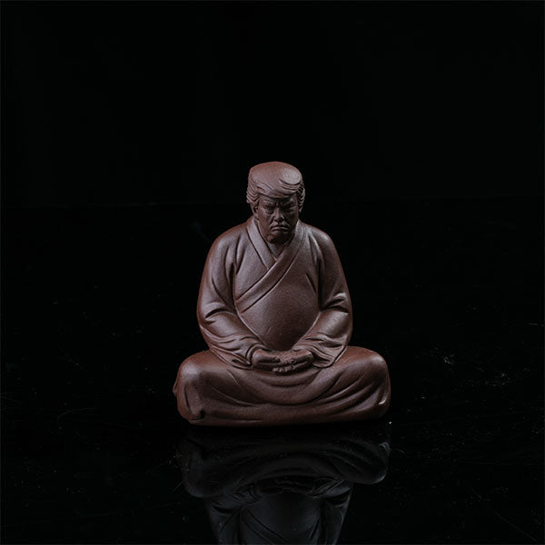 This is a purple clay tea pet with the image of Trump.