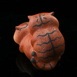 This is a purple clay tea pet with two little tigers hugging and sleeping.